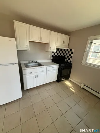 a kitchen with cabinets and window
