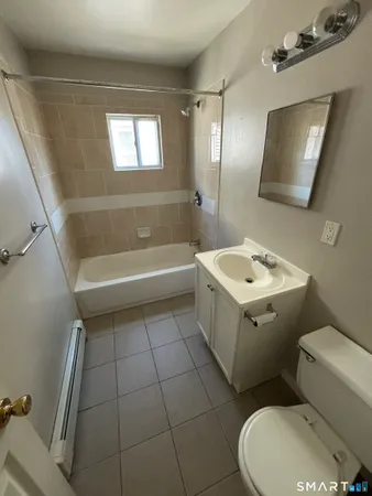 a bathroom with a sink a toilet and bathtub
