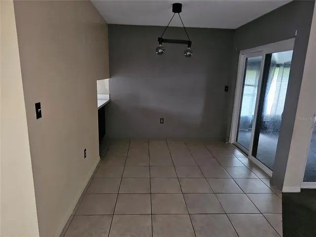 a view of an empty room with a mirror