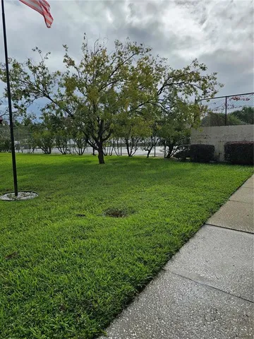 a view of a field of grass and trees