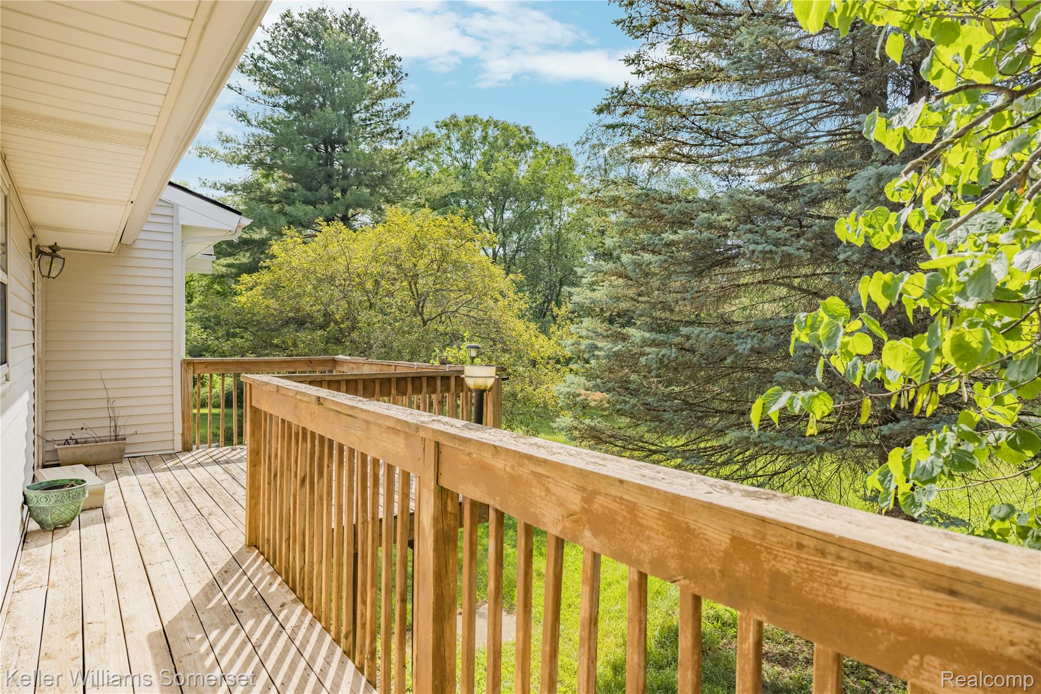 2344 Rochester Road Leonard, MI 48367 - Photo 48 of 66 Spacious wood deck with natural wood railing overlooking a verdant tree line