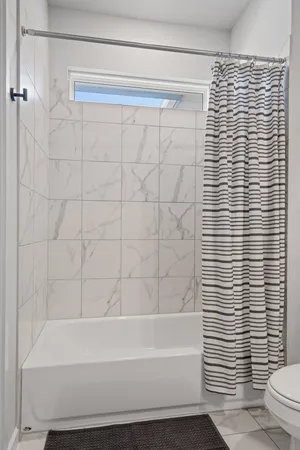 a bathroom with a shower and a toilet