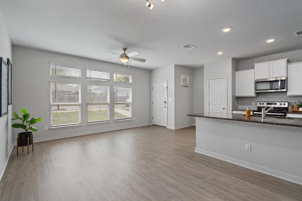 a view of kitchen with sink and wooden floor