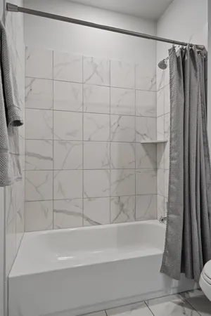 a bathroom with a shower and a bath tub