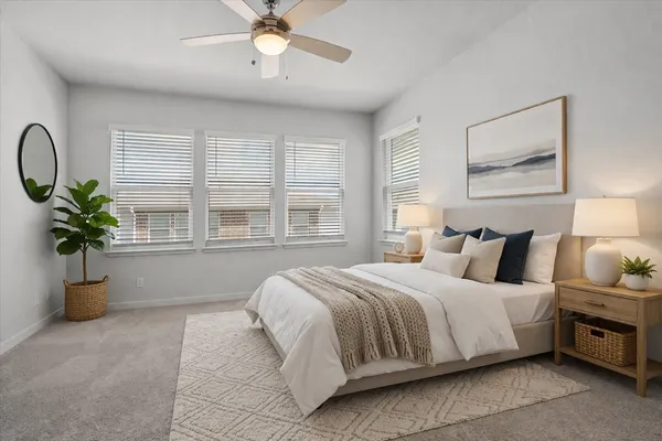 a bedroom with a bed and potted plant