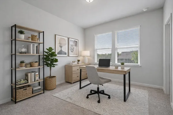 a view of a workspace with furniture and a window