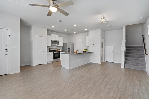 a view of kitchen with refrigerator microwave and stove