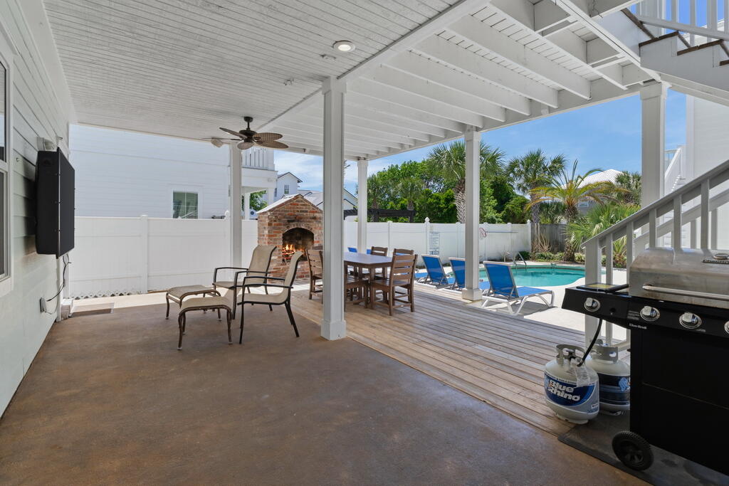 64 Dolphin Street Destin, FL 32541 - Photo 15 of 107 a living room with patio furniture and a flat screen tv