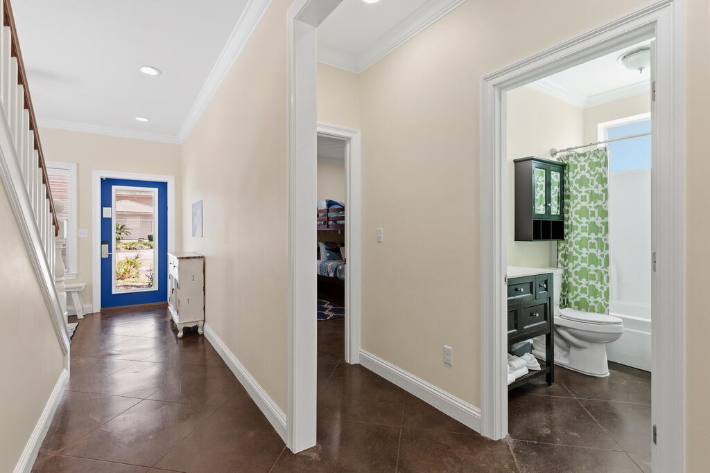 64 Dolphin Street Destin, FL 32541 - Photo 31 of 107 a view of a hallway with wooden floor and a livingroom