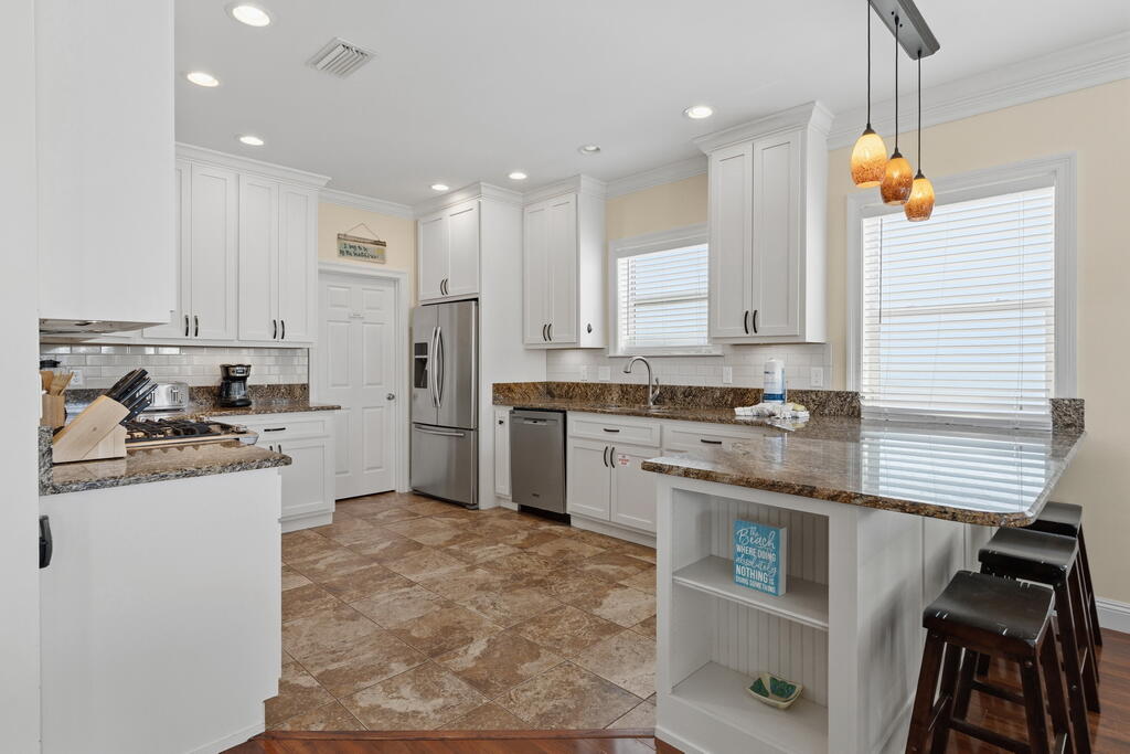 64 Dolphin Street Destin, FL 32541 - Photo 50 of 107 a kitchen with a sink appliances and cabinets