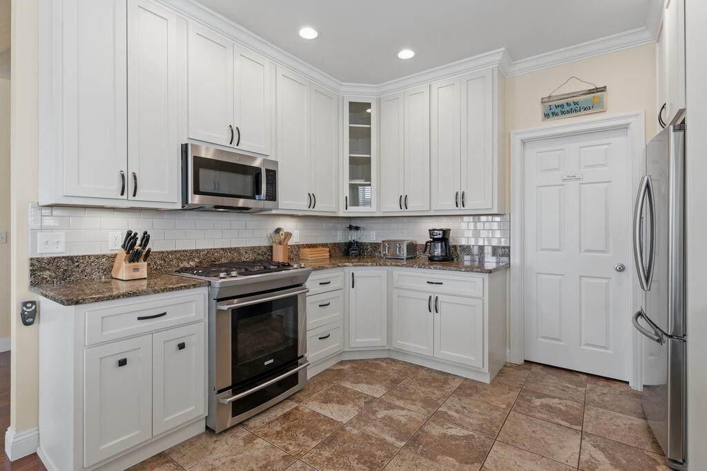 64 Dolphin Street Destin, FL 32541 - Photo 52 of 107 a kitchen with stainless steel appliances granite countertop a stove a sink and a refrigerator