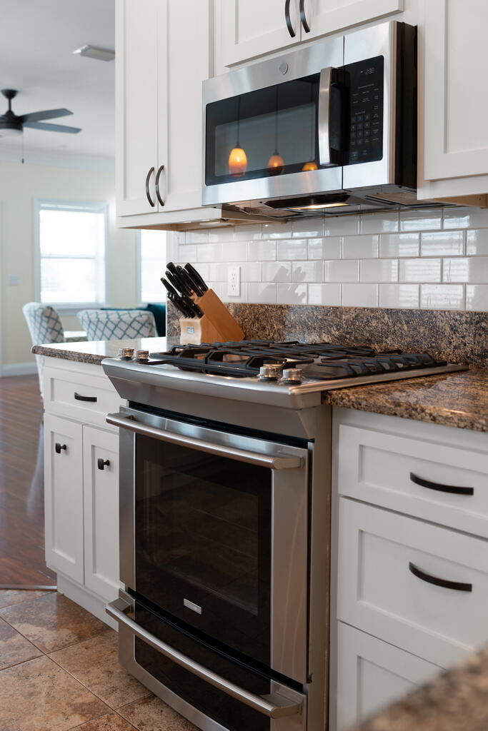 64 Dolphin Street Destin, FL 32541 - Photo 55 of 107 a kitchen with granite countertop a stove microwave and sink