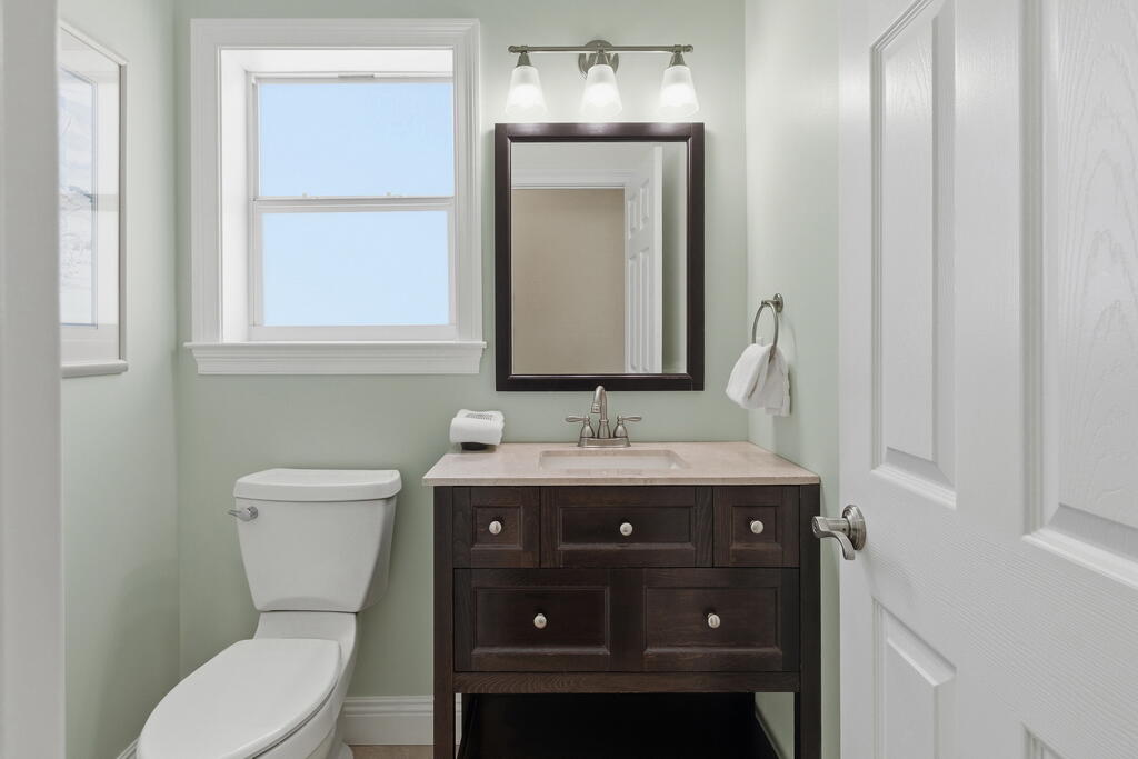 64 Dolphin Street Destin, FL 32541 - Photo 62 of 107 a bathroom with a toilet a sink and mirror
