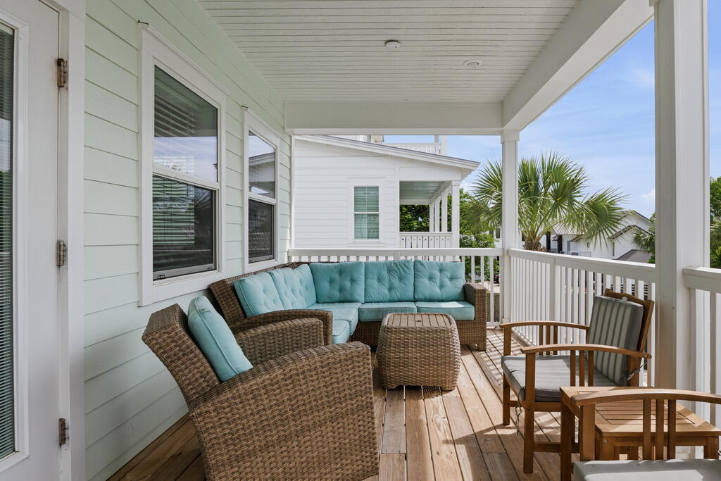 64 Dolphin Street Destin, FL 32541 - Photo 64 of 107 a balcony with furniture and a potted plant