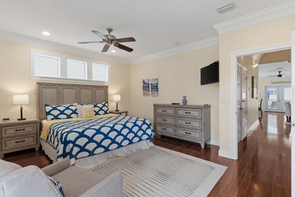 64 Dolphin Street Destin, FL 32541 - Photo 65 of 107 a bedroom with a bed and a flat tv screen on dresser