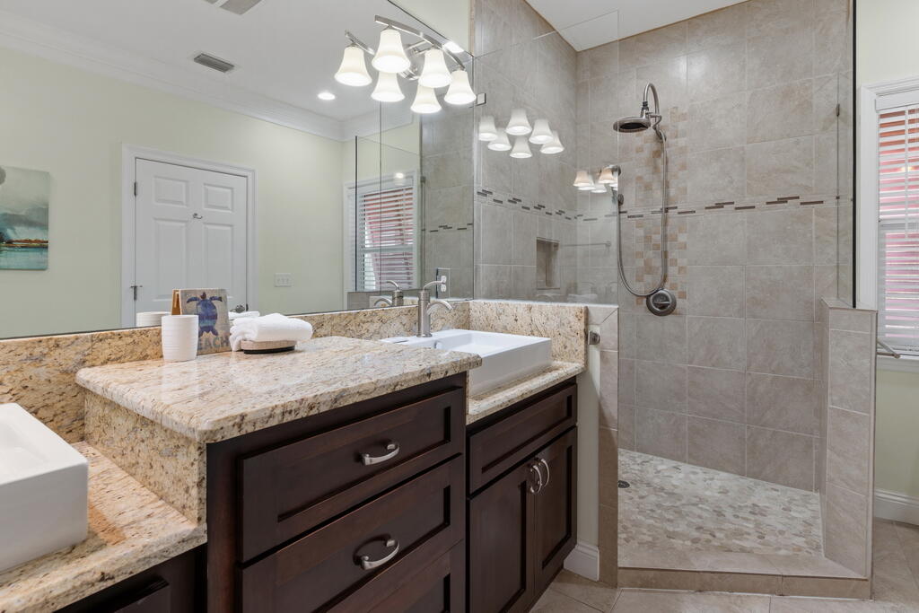 64 Dolphin Street Destin, FL 32541 - Photo 72 of 107 a bathroom with a granite countertop sink a large mirror and shower