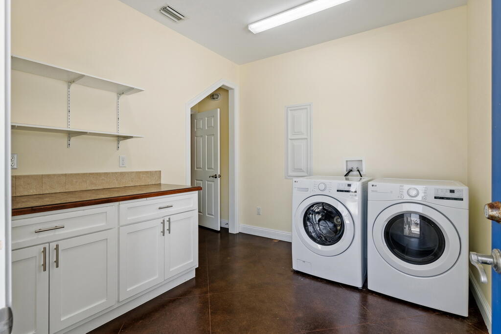 64 Dolphin Street Destin, FL 32541 - Photo 78 of 107 a utility room with sink dryer and washer