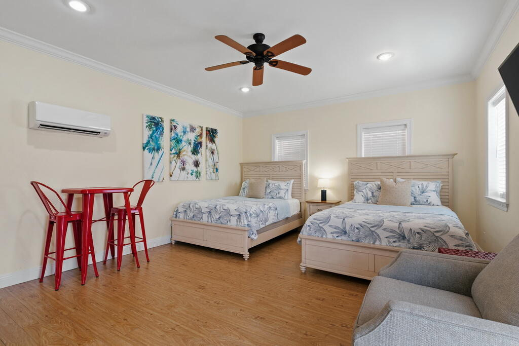 64 Dolphin Street Destin, FL 32541 - Photo 88 of 107 a bedroom with a bed and a couch