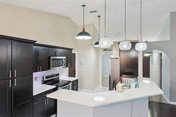 a kitchen with cabinets and stainless steel appliances