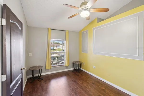 a view of room with wooden floor and fan
