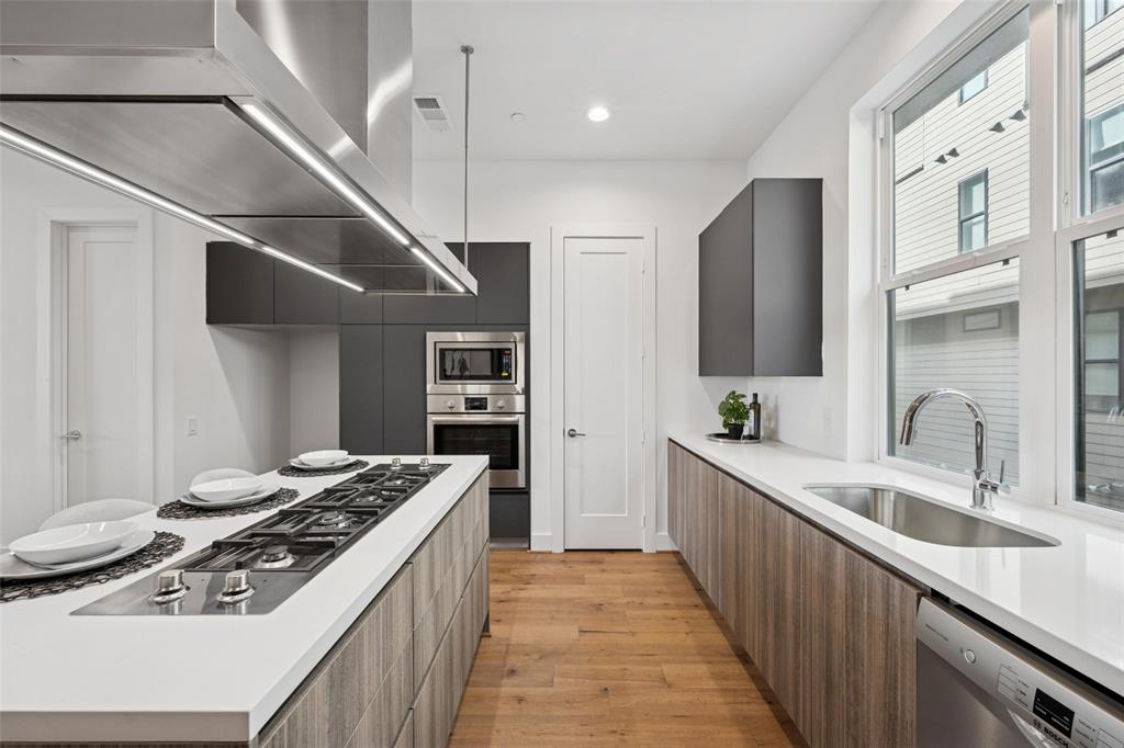 3064 ChImes Street Dallas, TX 75219 - Photo 11 of 40 a kitchen with stainless steel appliances granite countertop a sink stove and refrigerator