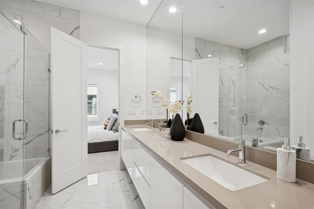 3064 ChImes Street Dallas, TX 75219 - Photo 15 of 40 a bathroom with double vanity sink a mirror and a shower