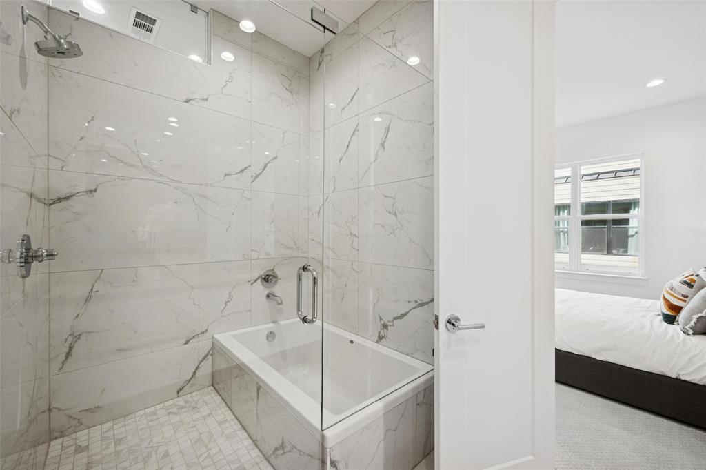 3064 ChImes Street Dallas, TX 75219 - Photo 16 of 40 a bathroom with a tub a sink and a shower