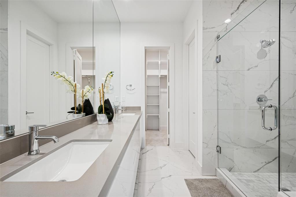 3064 ChImes Street Dallas, TX 75219 - Photo 17 of 40 a bathroom with a tub sink and glass door