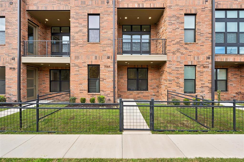 3064 ChImes Street Dallas, TX 75219 - Photo 2 of 40 a front view of a house with a garden and plants