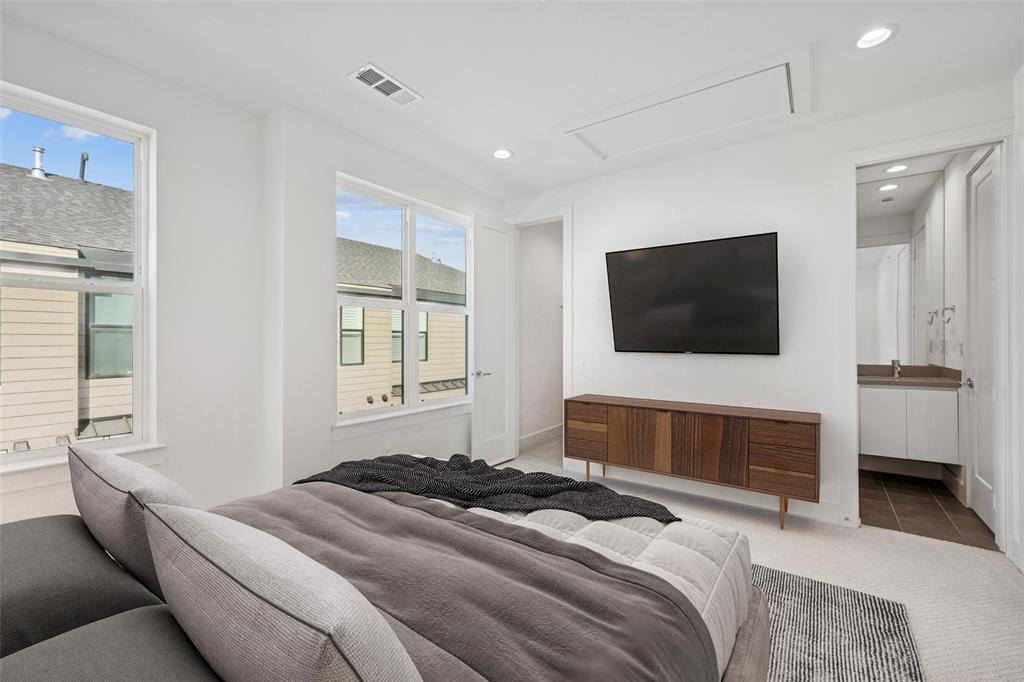 3064 ChImes Street Dallas, TX 75219 - Photo 26 of 40 a bedroom with a bed and a flat screen tv