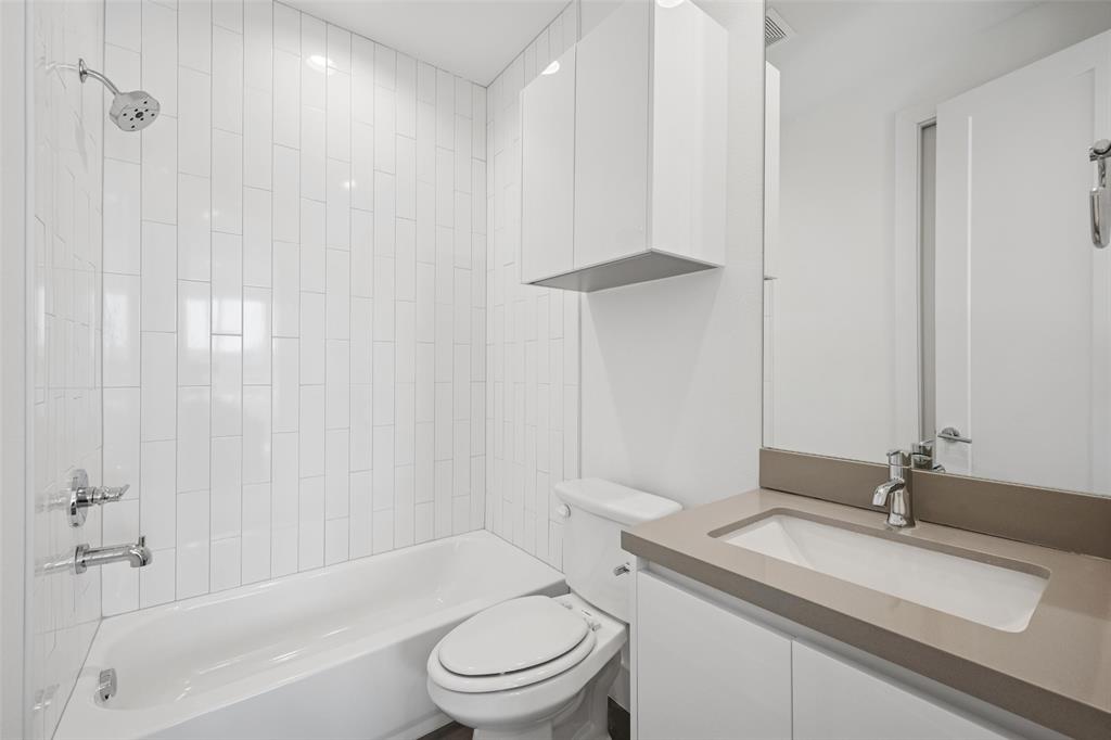 3064 ChImes Street Dallas, TX 75219 - Photo 27 of 40 a bathroom with a granite countertop sink toilet and shower