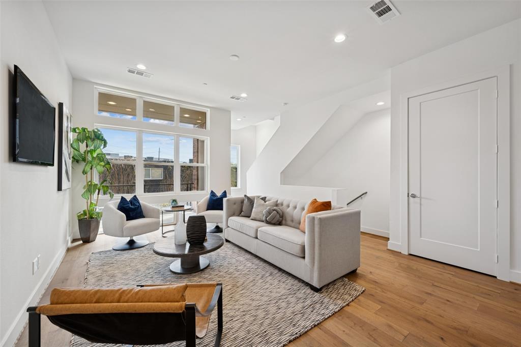 3064 ChImes Street Dallas, TX 75219 - Photo 5 of 40 a living room with furniture a large window and a flat screen tv