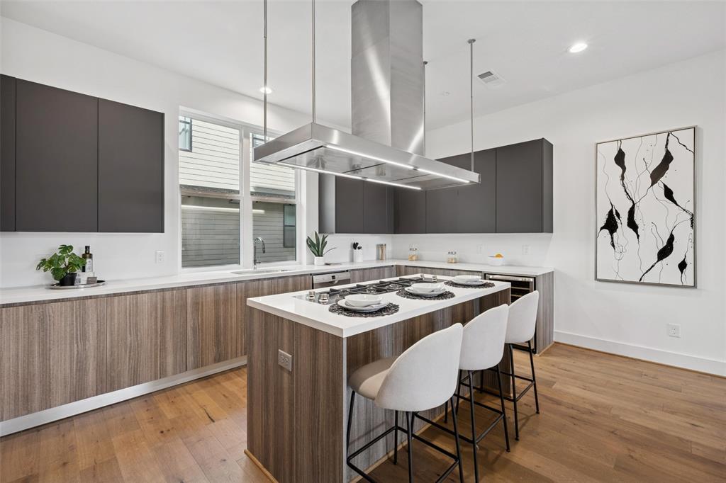 3064 ChImes Street Dallas, TX 75219 - Photo 10 of 40 a kitchen with a stove a table and chairs in it