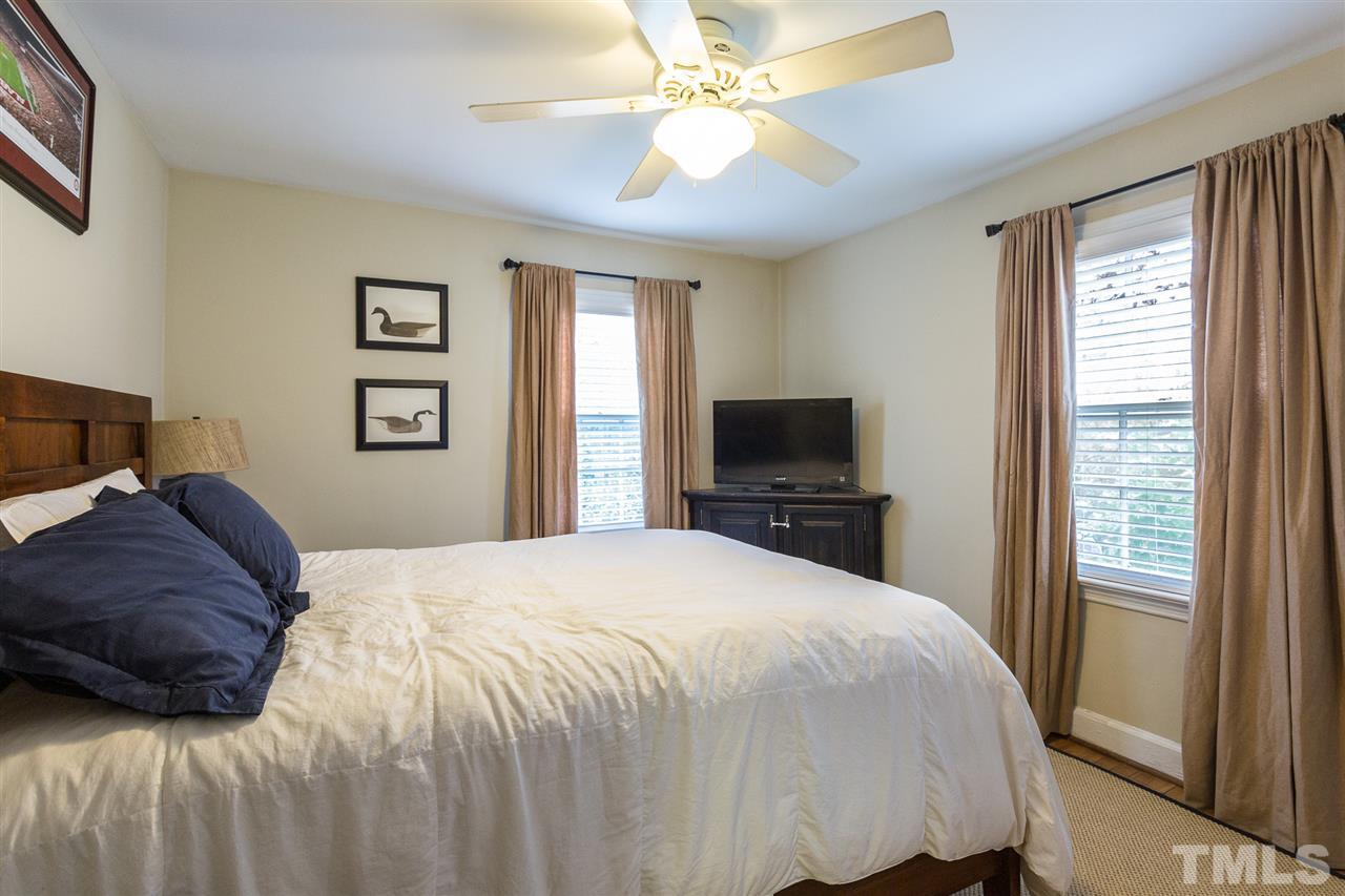 3008 Medlin Drive Raleigh, NC 27607 - Photo 15 of 29 a bedroom with a bed and a tv
