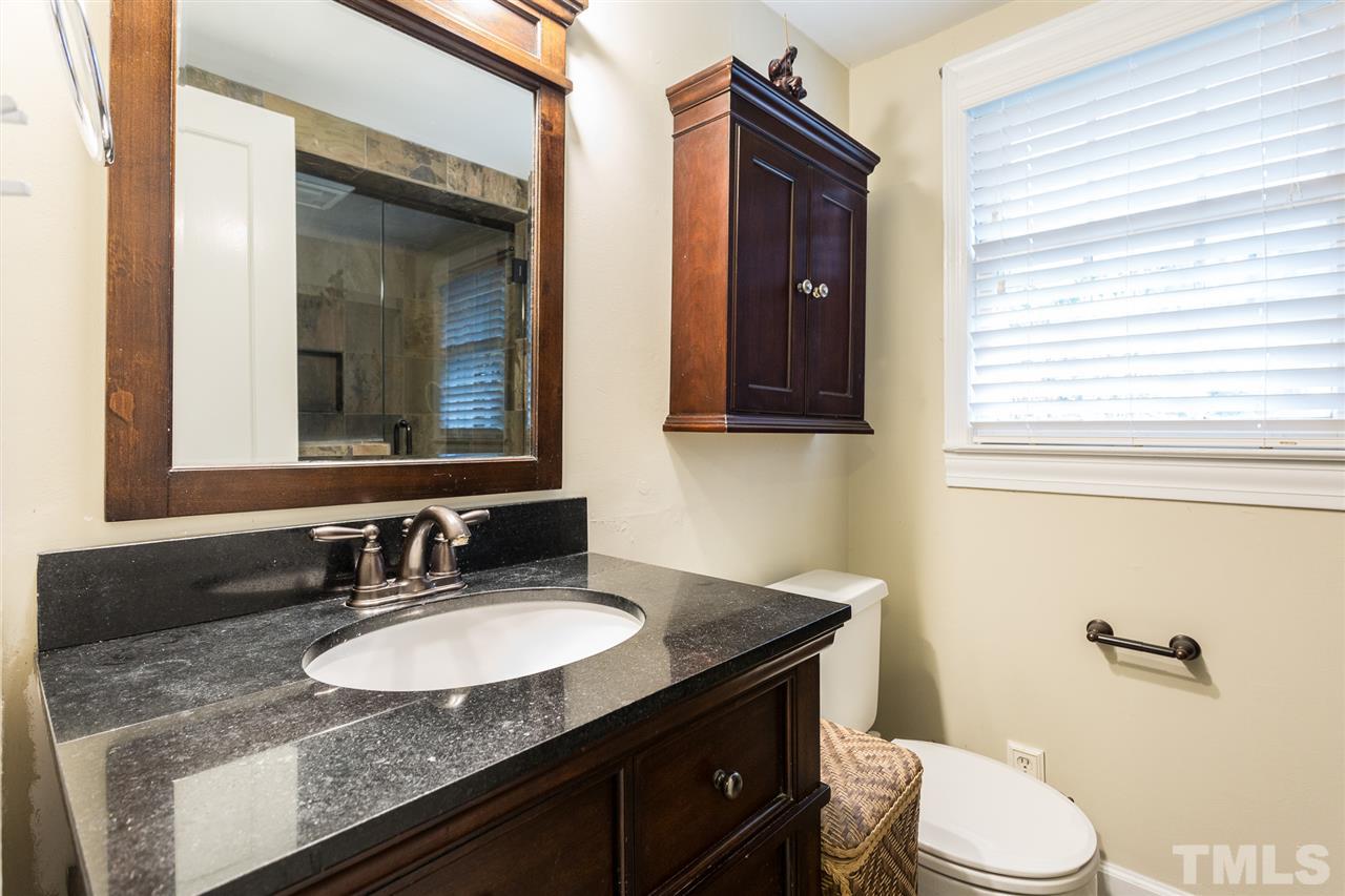 3008 Medlin Drive Raleigh, NC 27607 - Photo 18 of 29 a bathroom with a granite countertop sink vanity mirror and toilet