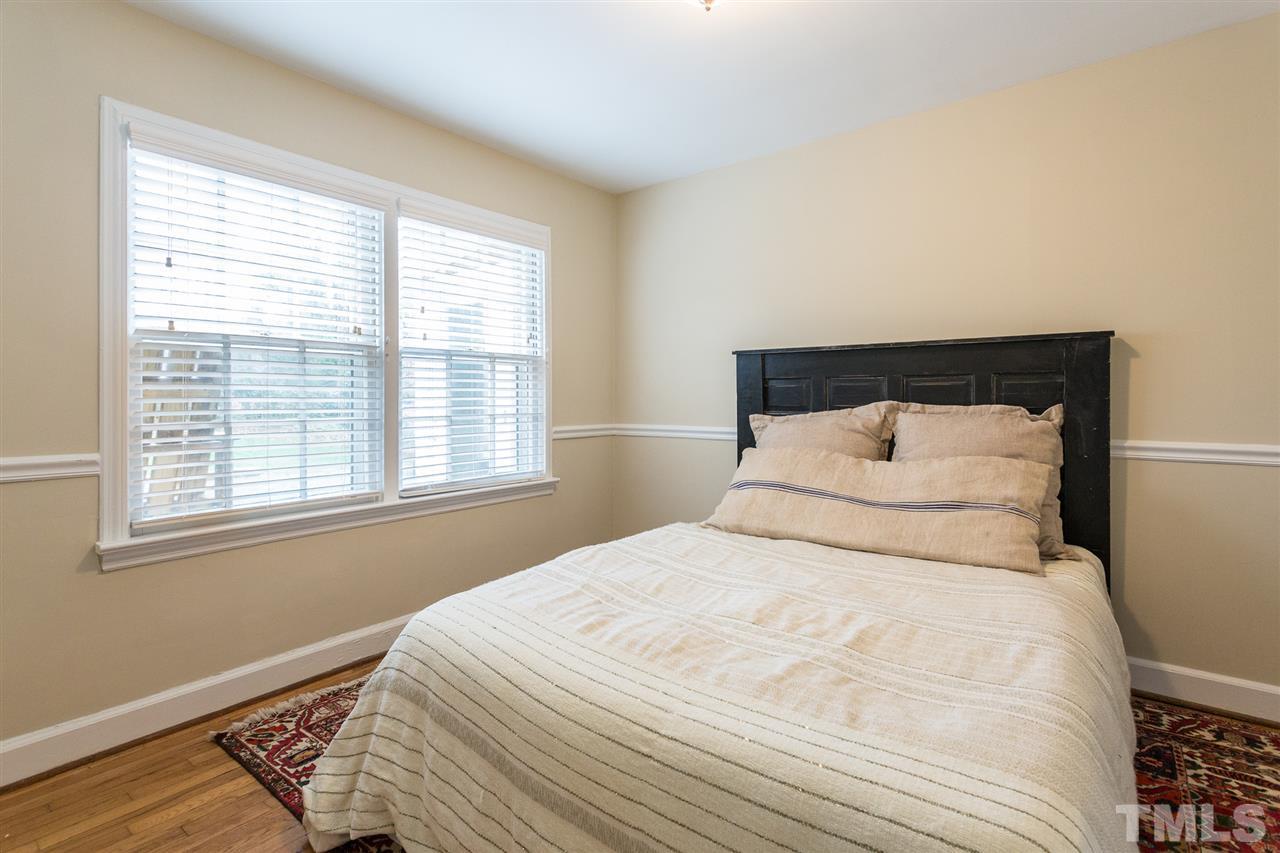 3008 Medlin Drive Raleigh, NC 27607 - Photo 20 of 29 a large white bed in a small room next to a window