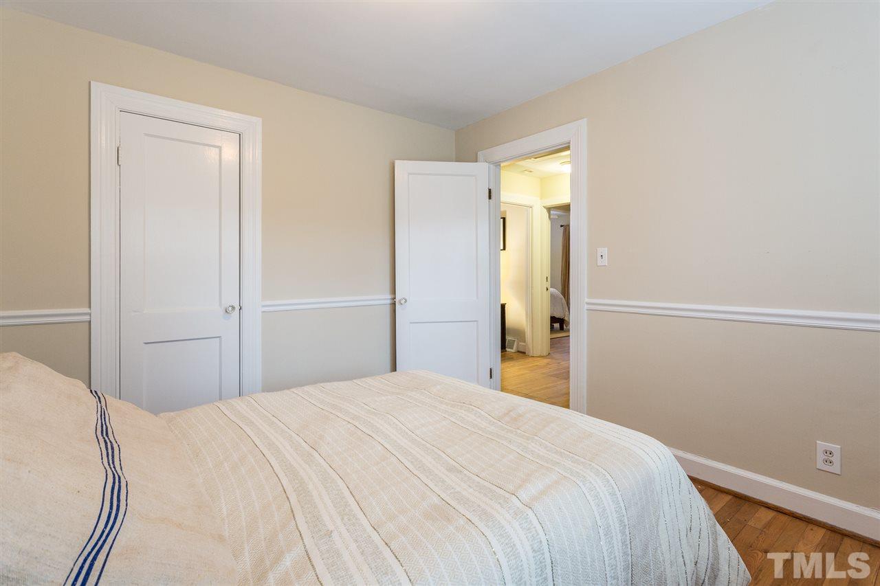 3008 Medlin Drive Raleigh, NC 27607 - Photo 21 of 29 a bedroom with a bed and a mirror