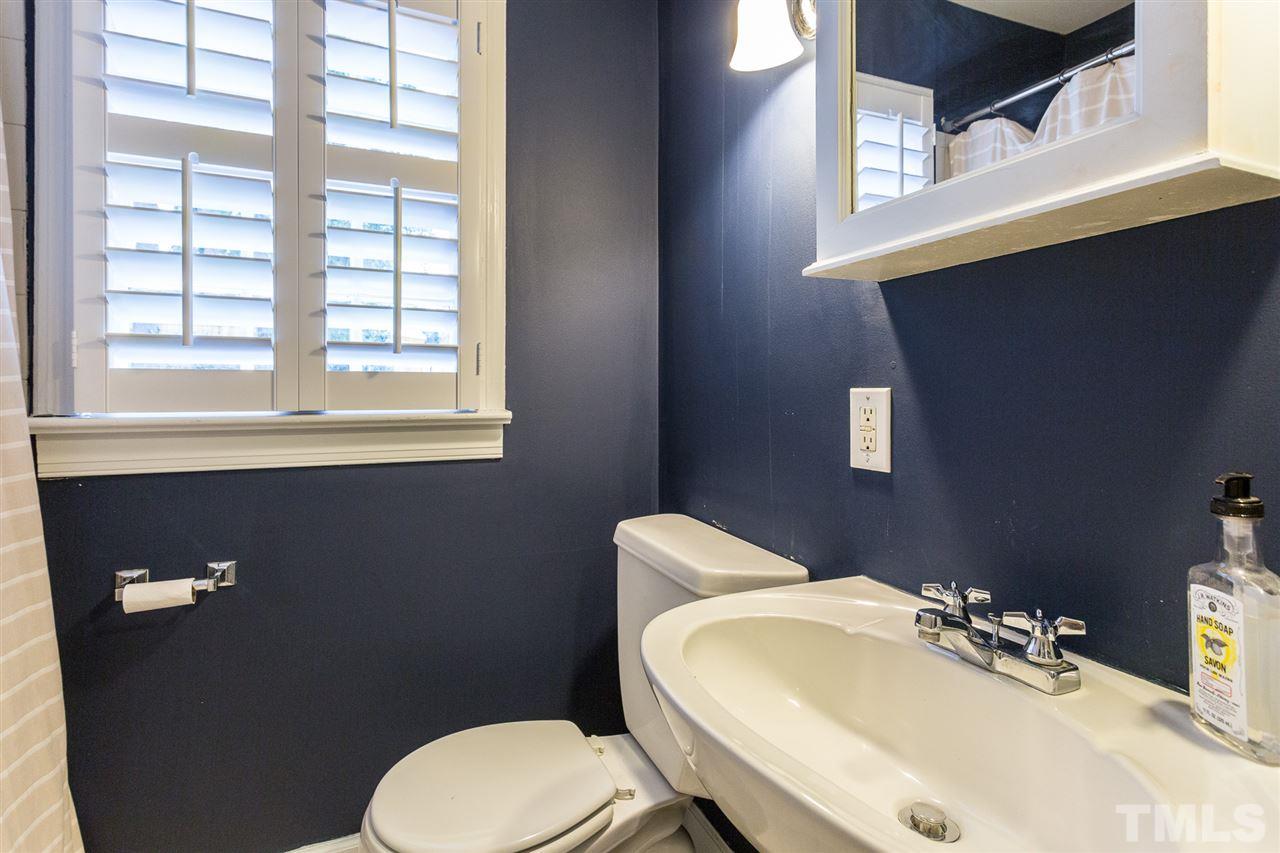 3008 Medlin Drive Raleigh, NC 27607 - Photo 22 of 29 a bathroom with a sink a toilet and a mirror