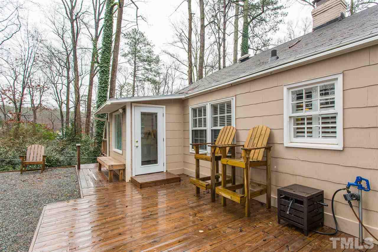 3008 Medlin Drive Raleigh, NC 27607 - Photo 23 of 29 a view of a patio with table and chairs with wooden floor and fence