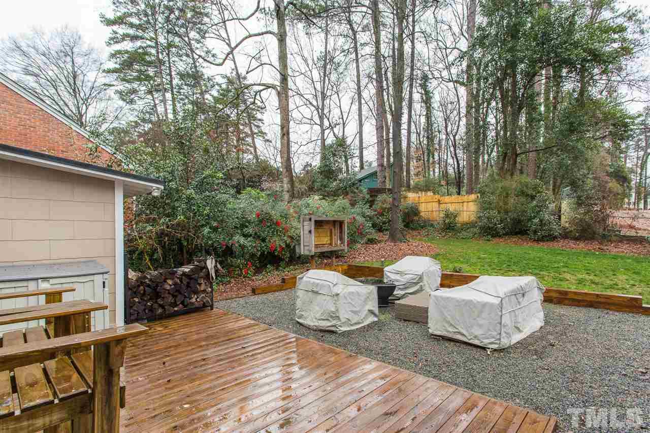3008 Medlin Drive Raleigh, NC 27607 - Photo 26 of 29 a view of a patio with couches table and chairs under an umbrella