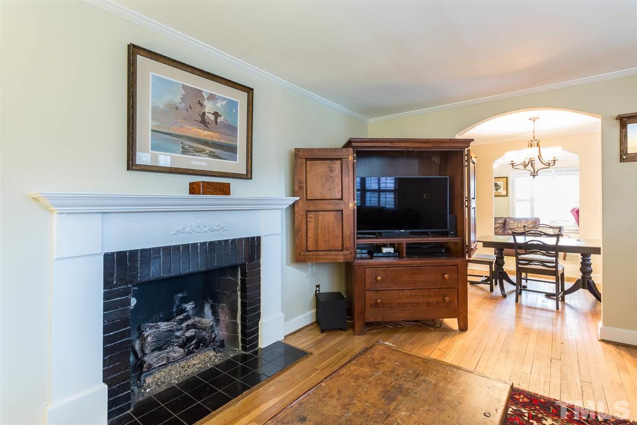 3008 Medlin Drive Raleigh, NC 27607 - Photo 5 of 29 a living room with furniture a flat screen tv and a fireplace