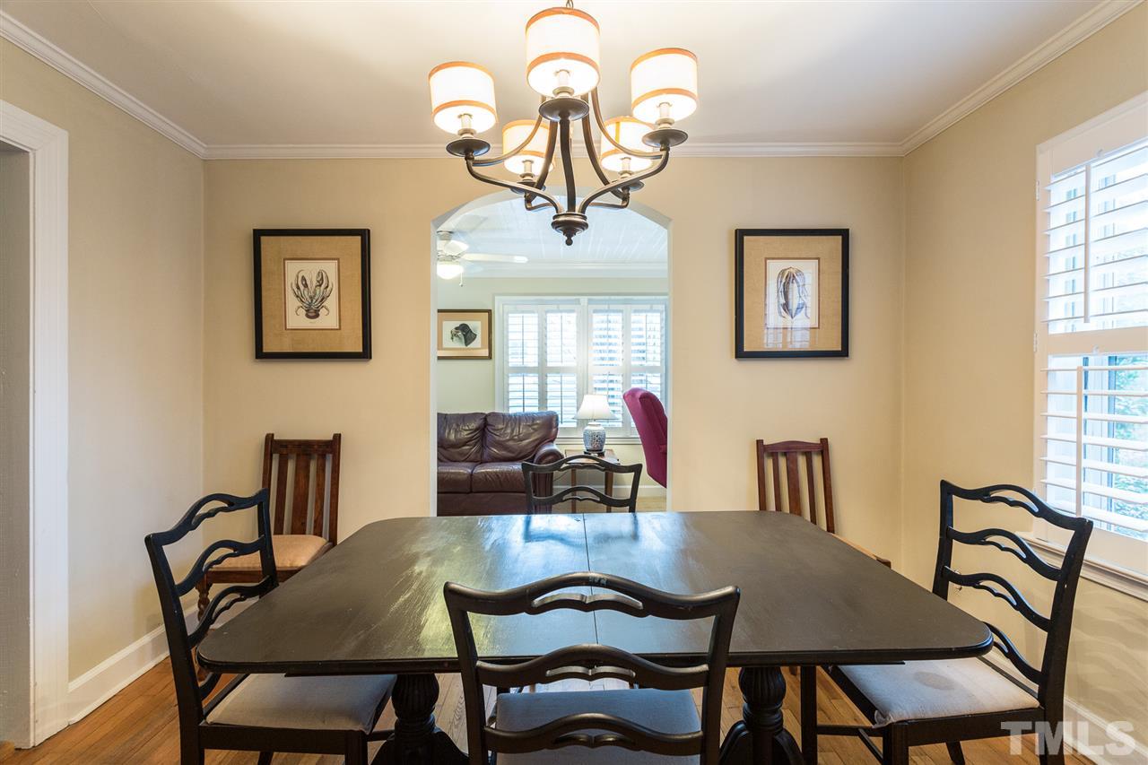 3008 Medlin Drive Raleigh, NC 27607 - Photo 7 of 29 a view of a dining room with furniture and chandelier