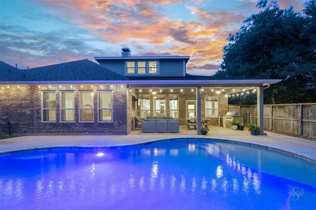 Outdoor living at it's finest! Discover your own personal backyard PARADISE complete with a custom built pool and spa, large covered patio with an outdoor kitchen and a FIRE PIT! It's the perfect place to spend a fun day or evening at home entertaining family and friends!