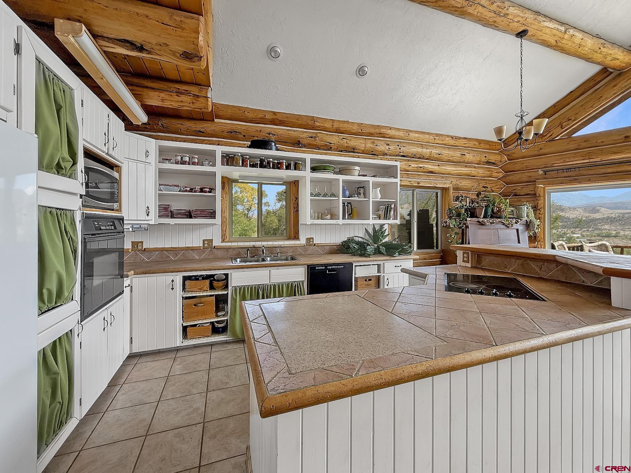 41263 Highway 133 Paonia, CO 81428 - Photo 14 of 44 a view of a kitchen with kitchen island table and chairs