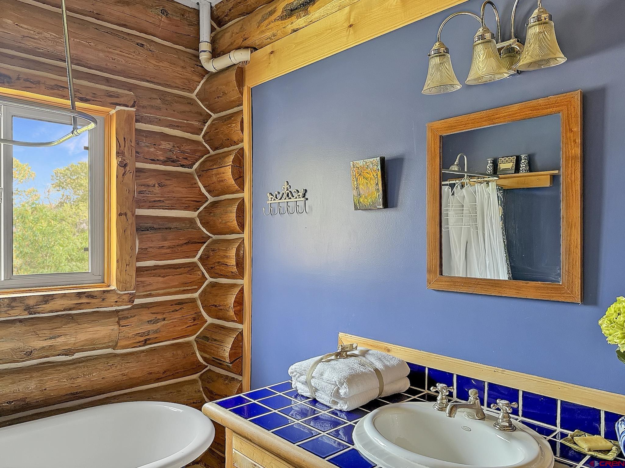 41263 Highway 133 Paonia, CO 81428 - Photo 28 of 44 a bathroom with a sink mirror vanity and toilet