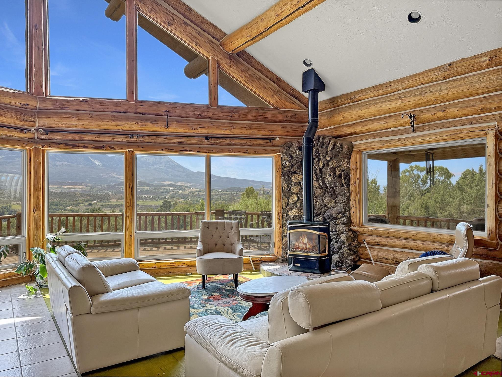 41263 Highway 133 Paonia, CO 81428 - Photo 9 of 44 a living room with furniture a ceiling fan and a large window