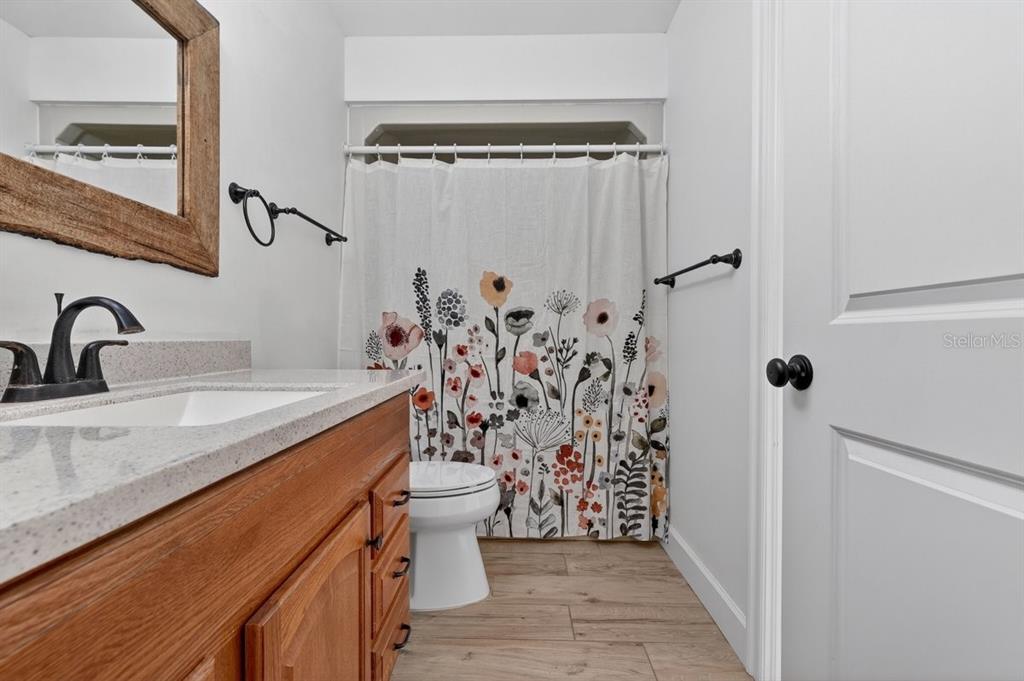 171 William Street Edgewater, FL 32141 - Photo 16 of 40 a bathroom with a granite countertop sink toilet and shower