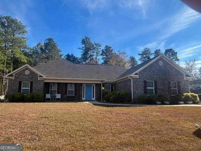 a front view of house with yard and green space