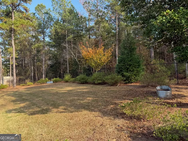 a backyard of a house with trees and entertaining space