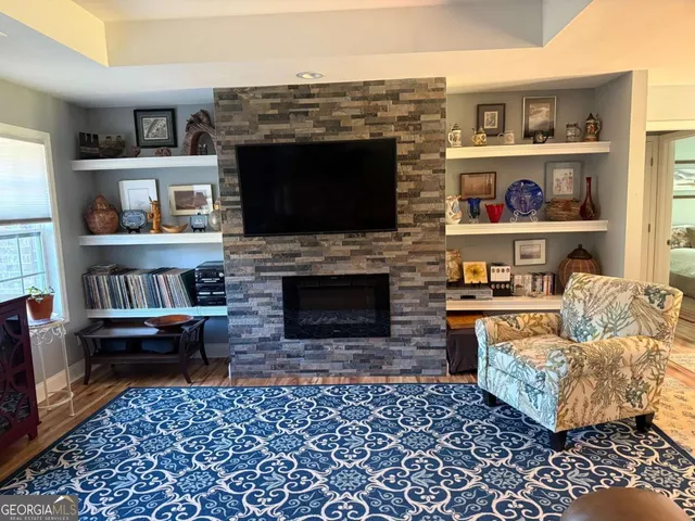 a living room with furniture and a fireplace